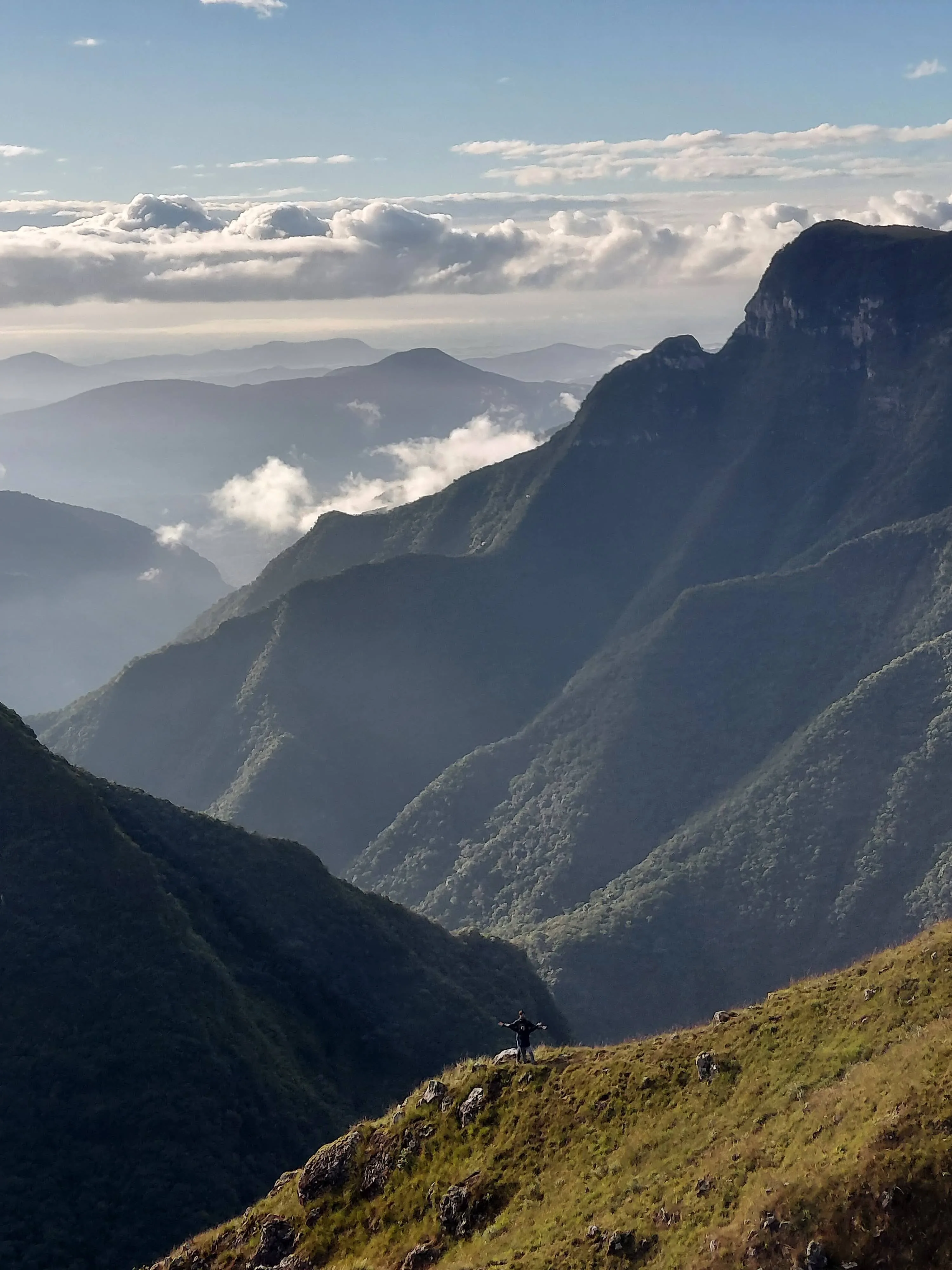 Vista panorâmica dos paredões rochosos e campos verdes dos cânions de São José dos Ausentes