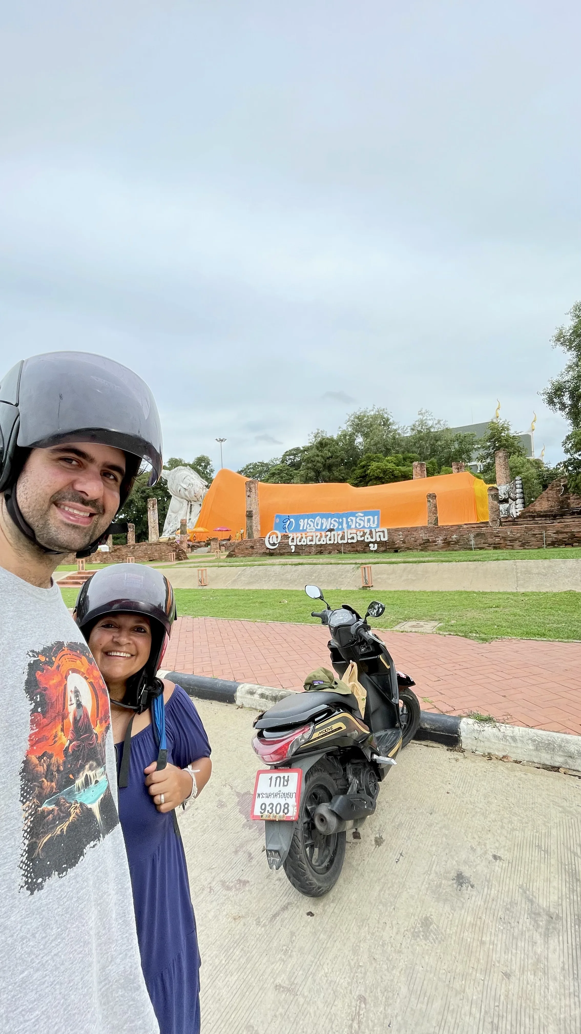 Casal em frente à grande estátua do Buda Deitado de Wat Khun Inthapramun na Tailândia